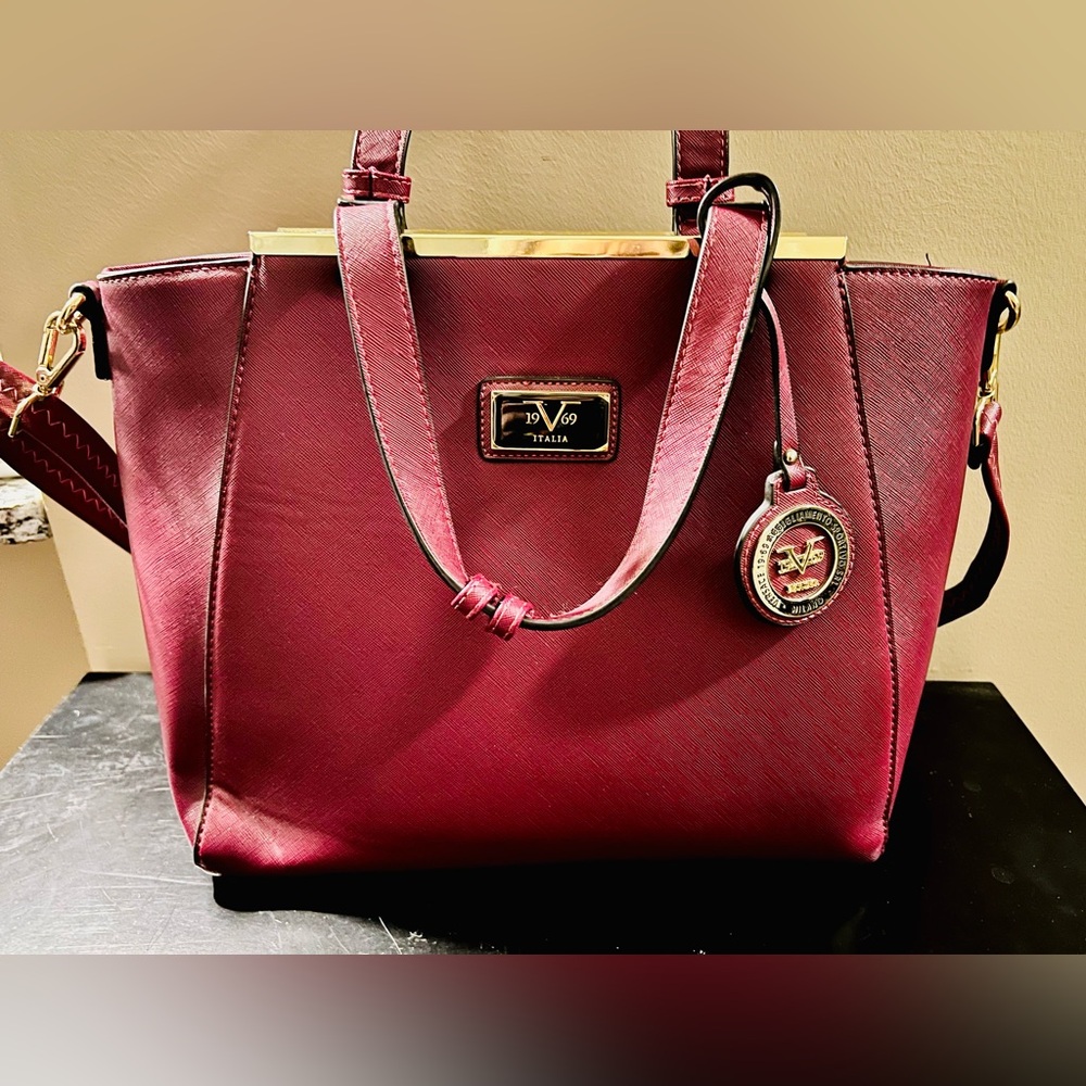 Versace 19v69 burgundy hand bag. Gold detailing. Brown lining. Like new.